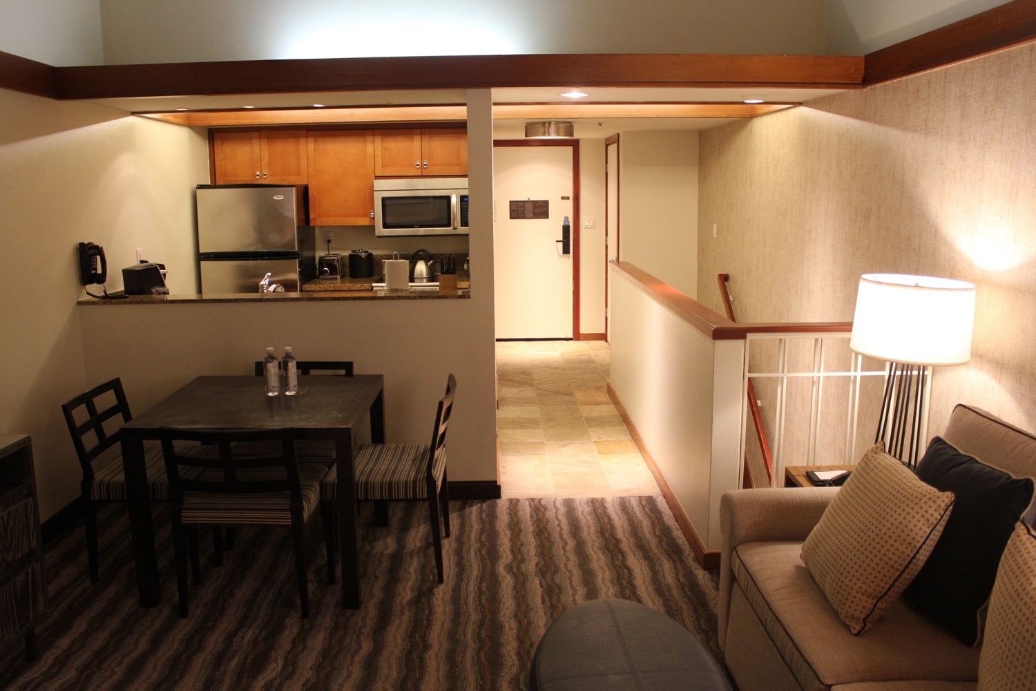 a living room with a kitchen and dining area