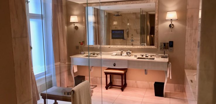 a bathroom with a large mirror and a bench