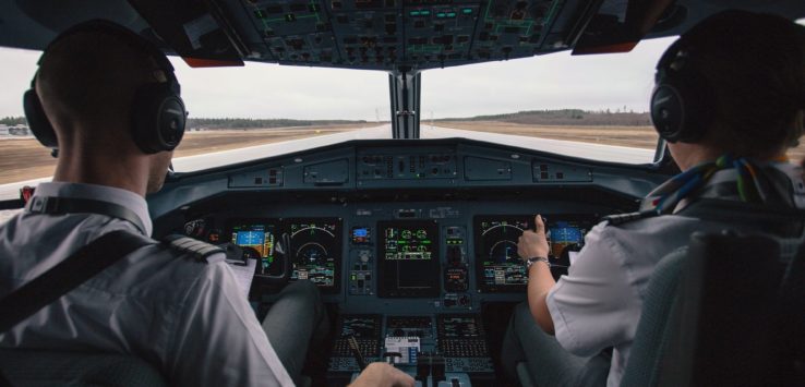 two men in the cockpit of an airplane