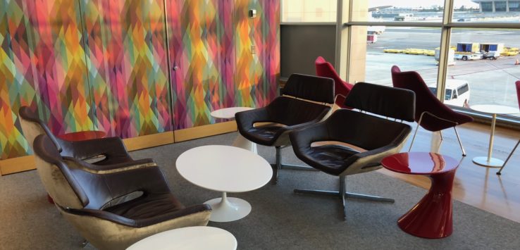 a group of chairs and tables in a room with windows