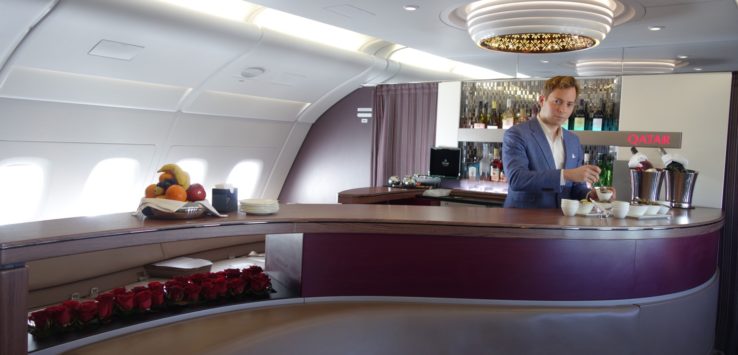 a man standing behind a counter in an airplane