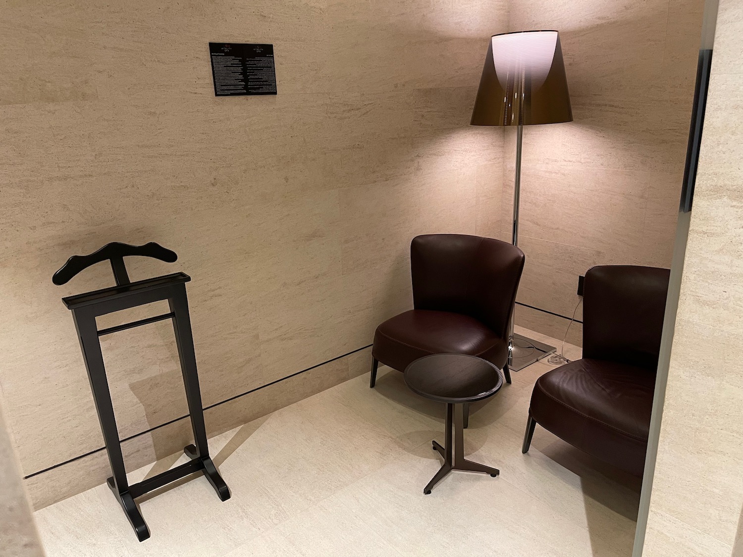 a room with chairs and a lamp