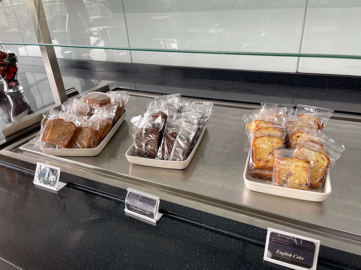 a trays of bread and sandwiches on a counter