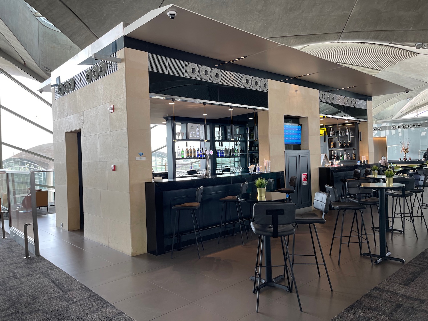 a bar with chairs and tables in a building