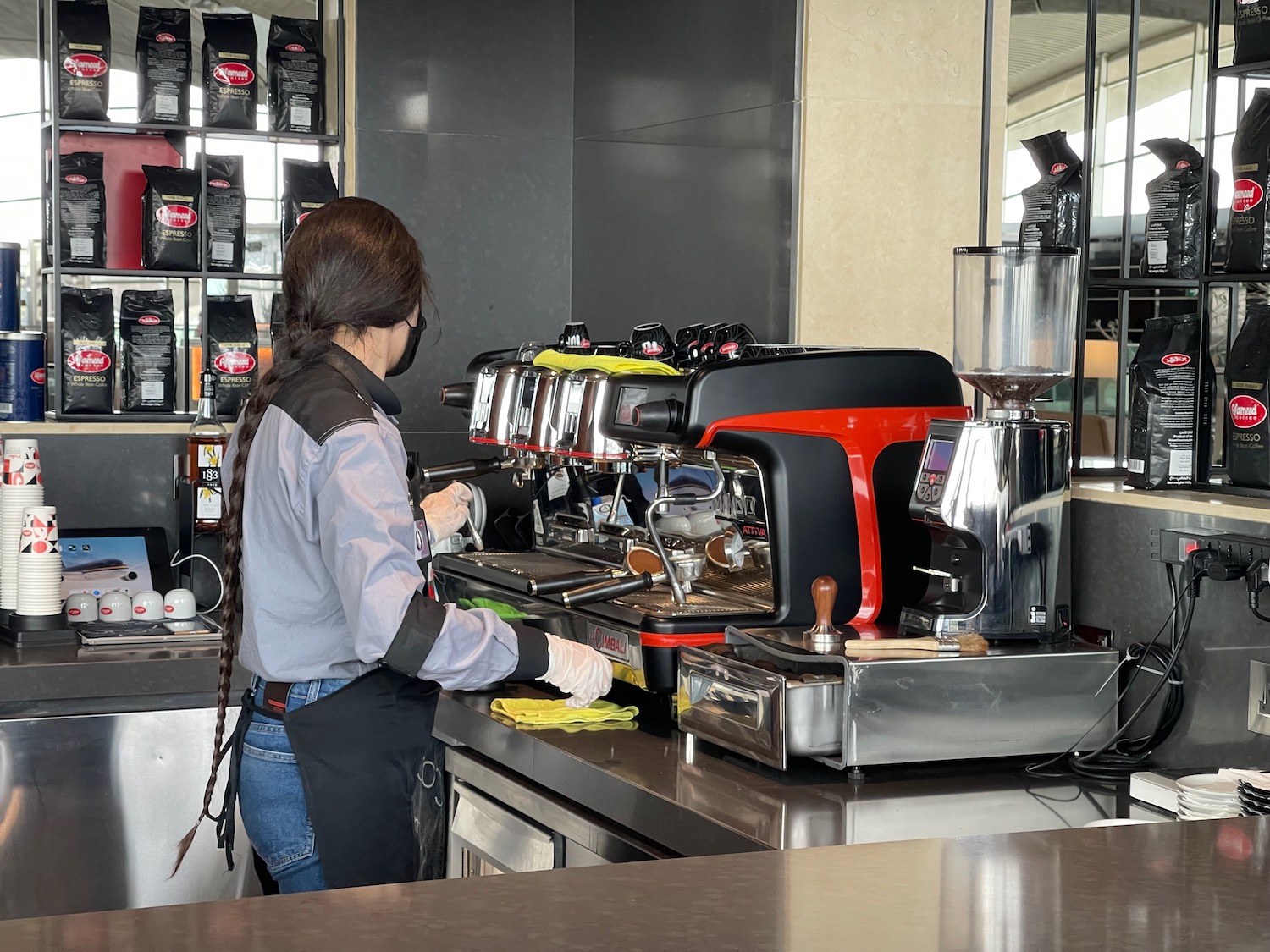 a woman working at a coffee machine