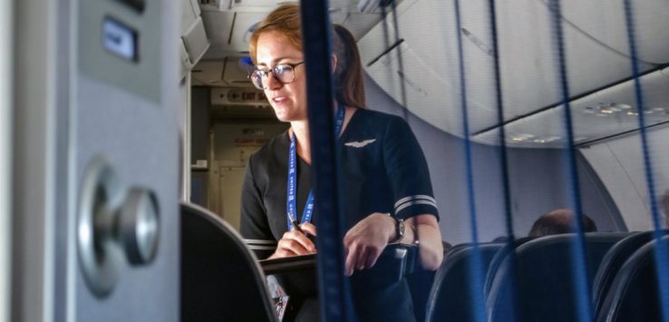 a woman in a uniform on an airplane