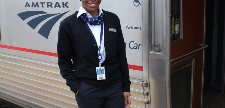 a woman standing in front of a train