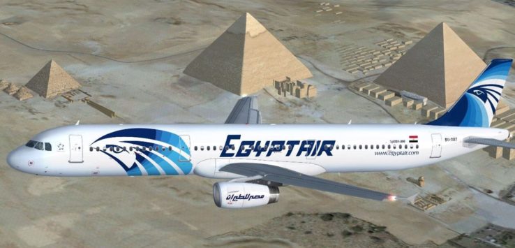 a plane flying over a pyramid