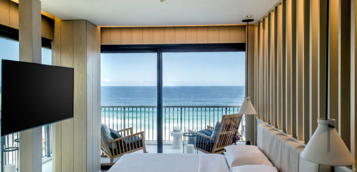 a room with a large window overlooking the ocean