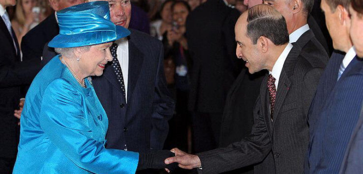 a man in a blue hat shaking hands with a woman in a blue hat