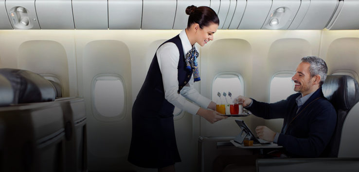 a woman serving a man on an airplane