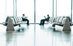 a group of men sitting in a waiting room