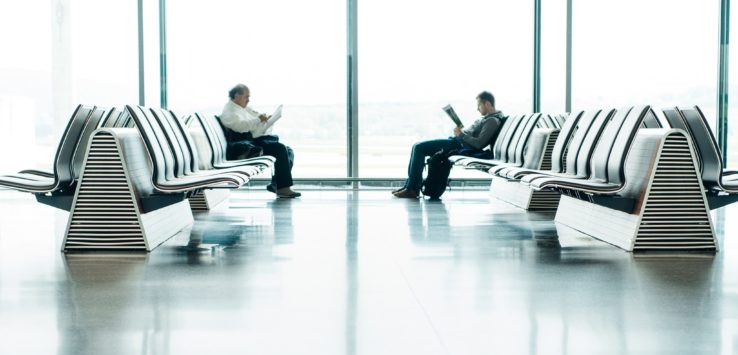 a group of men sitting in a waiting room