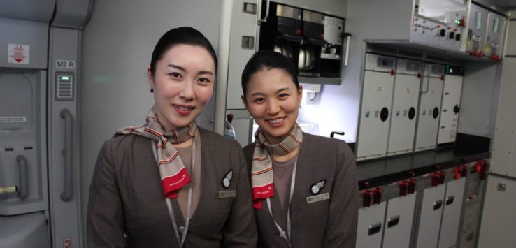 two women in uniform standing in a room