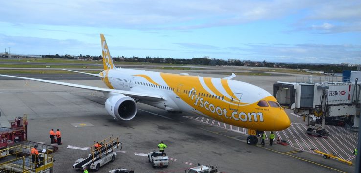 a large yellow and white airplane on a tarmac