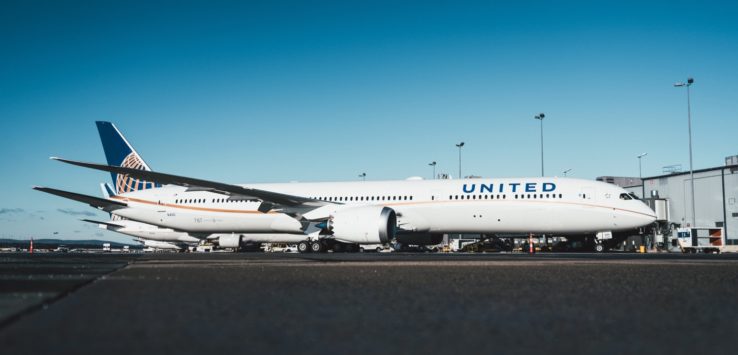 a large white airplane parked on a runway