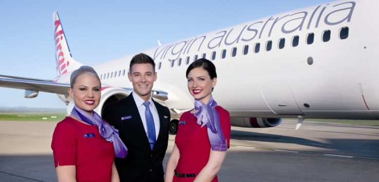 a group of people standing in front of an airplane