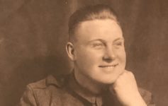 a man in uniform smiling