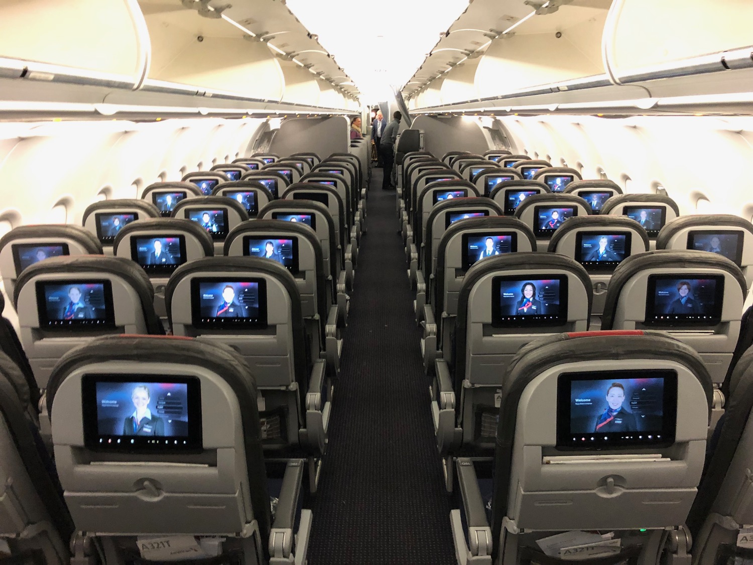 rows of seats with screens on the back