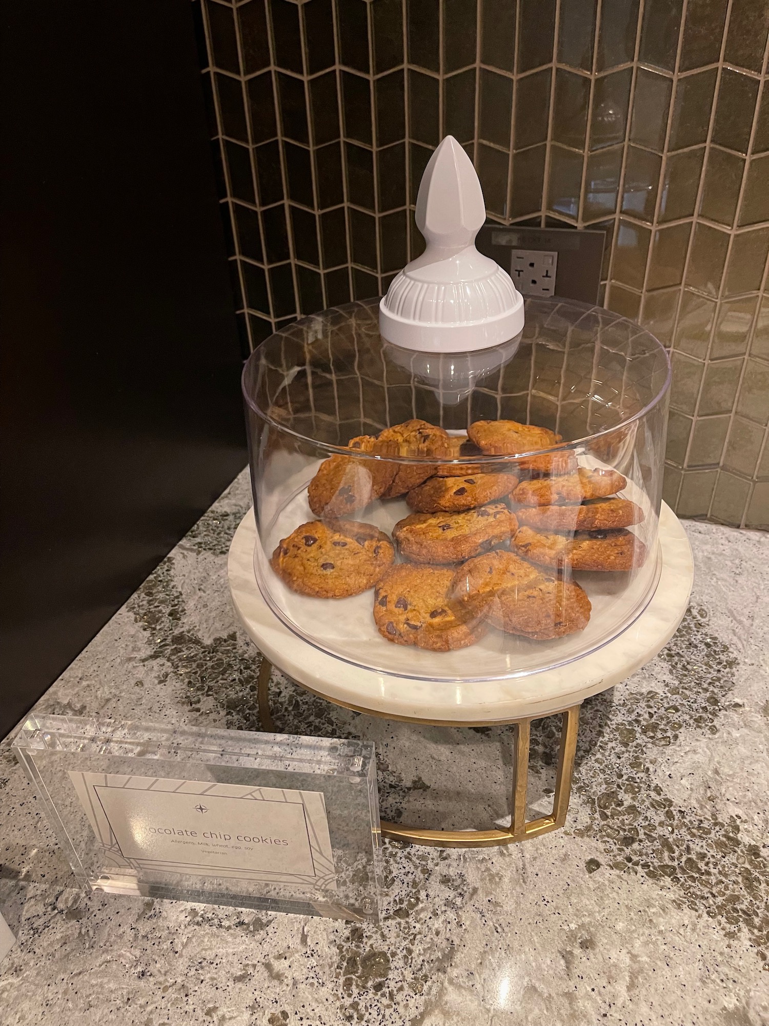 a glass container with cookies on it