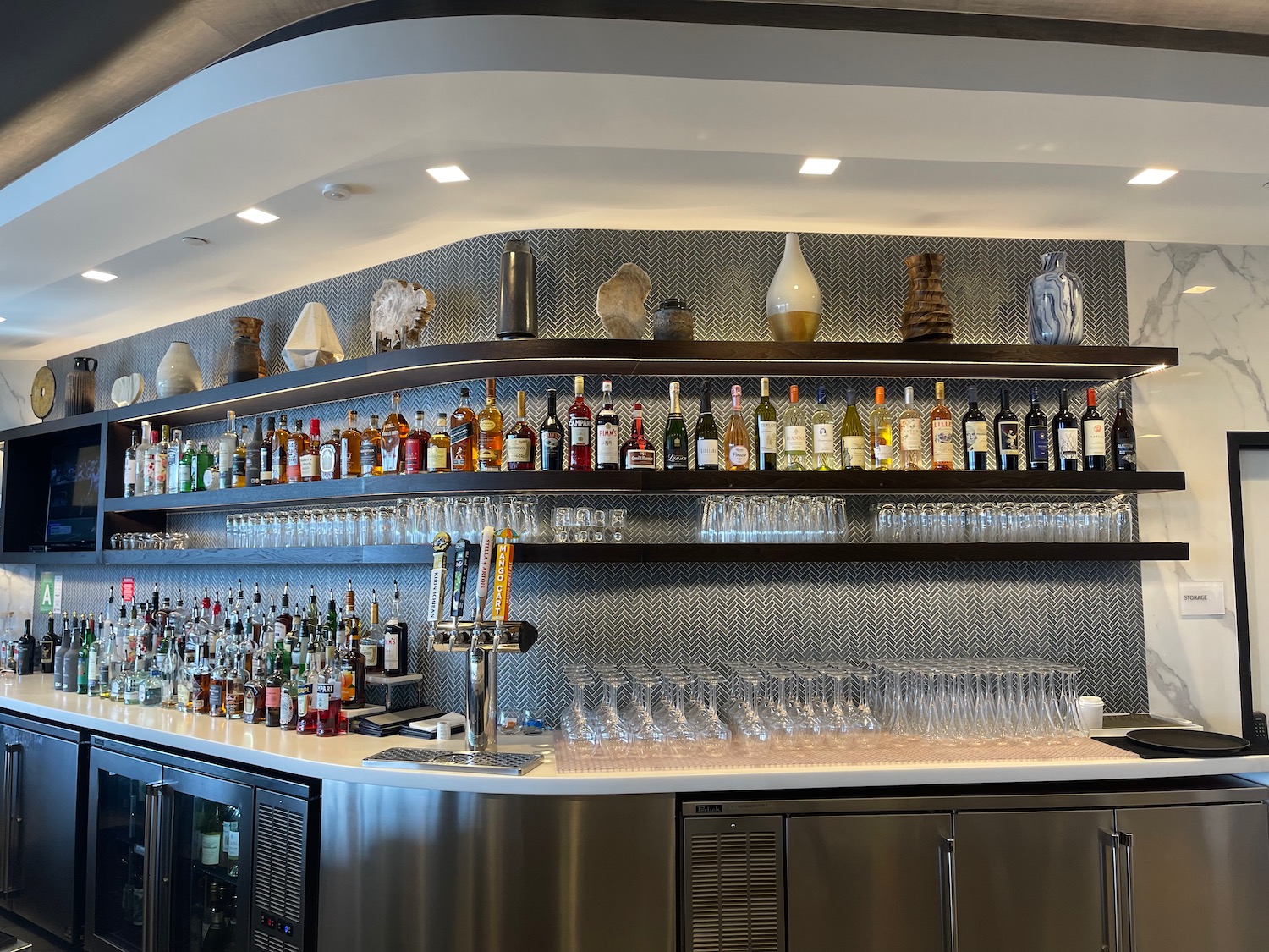 a bar with many bottles and glasses