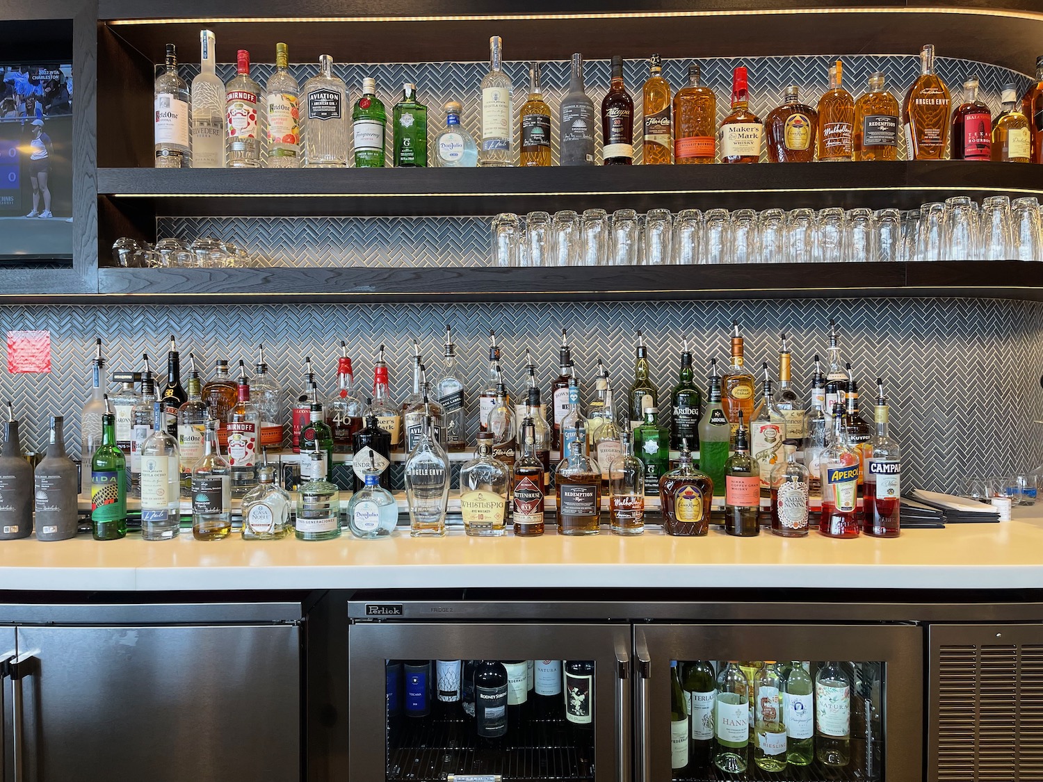 a shelf with bottles of alcohol