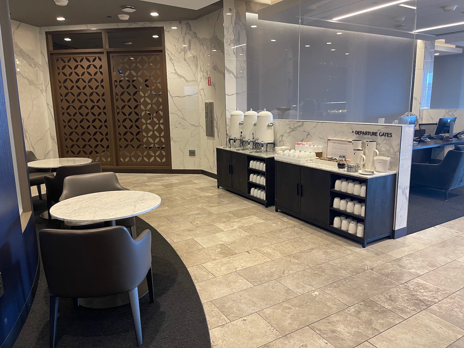 a room with a marble wall and a table and chairs