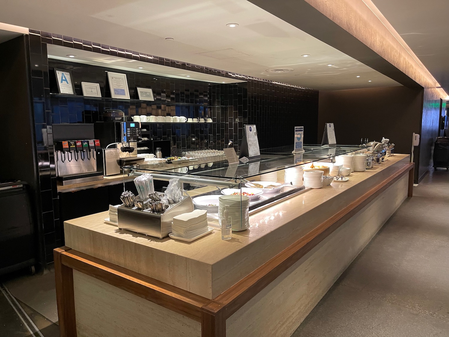 a buffet counter with plates and utensils