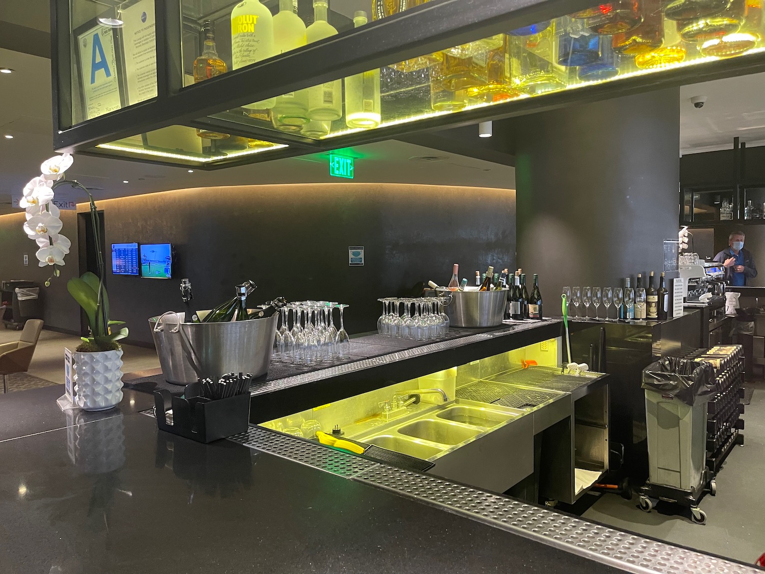 a bar with many glasses and bottles