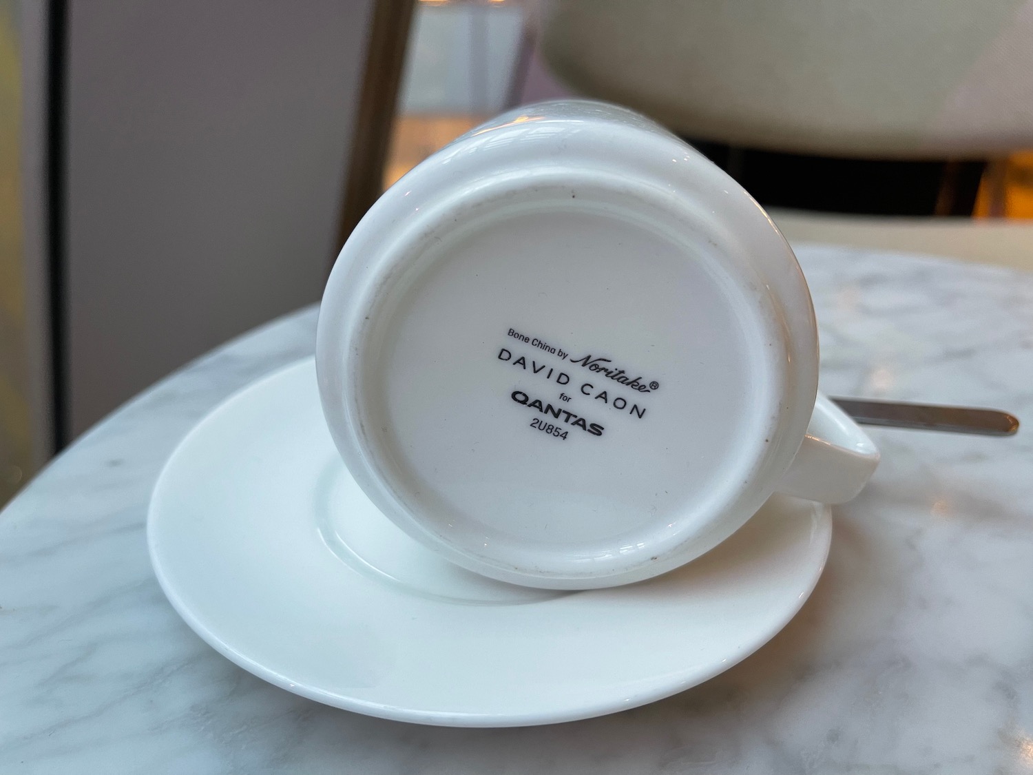 a white coffee cup on a saucer