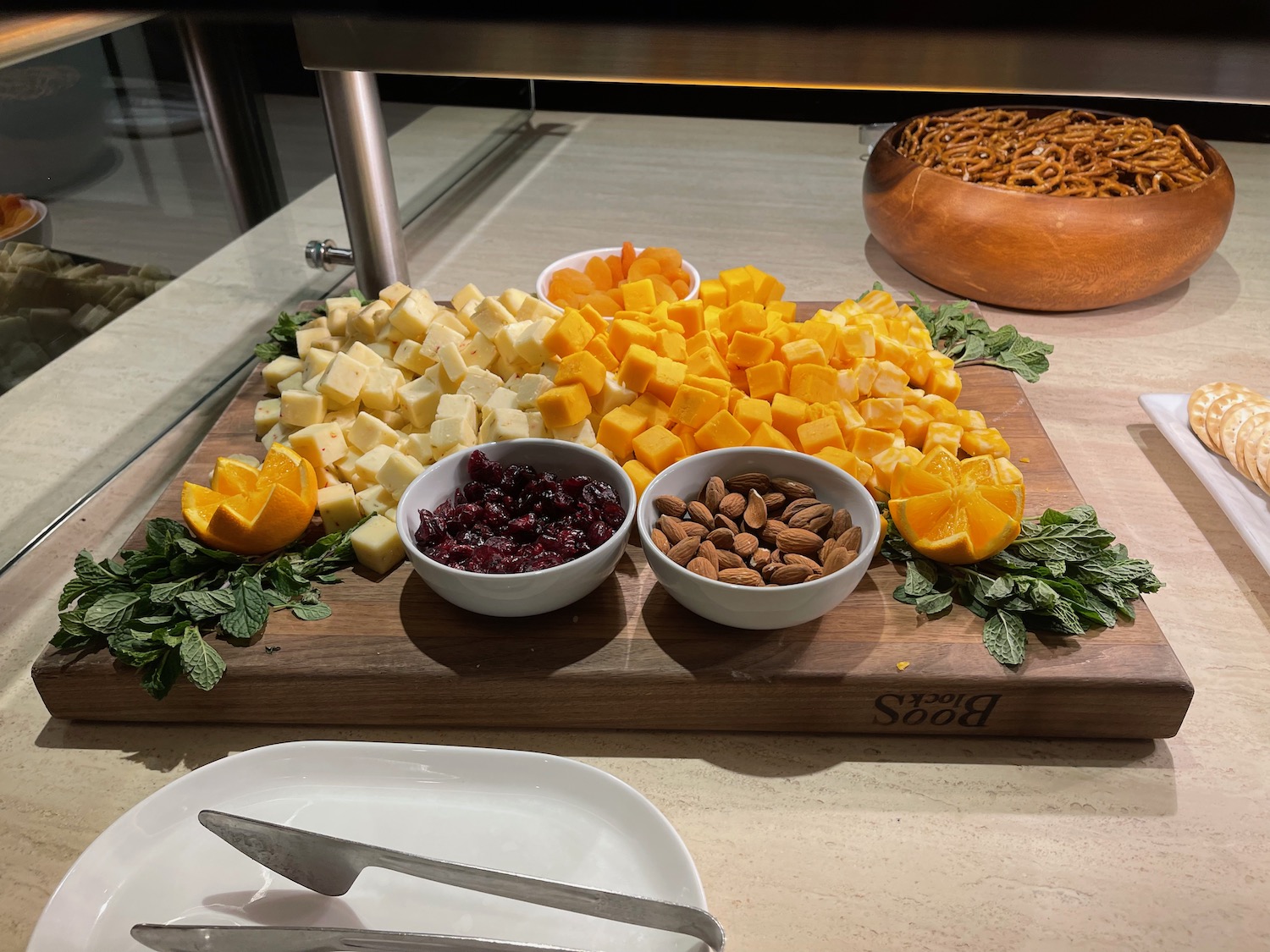 a cutting board with different types of cheese and nuts