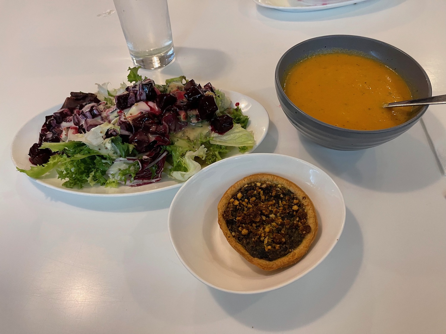 a plate of salad and soup on a table