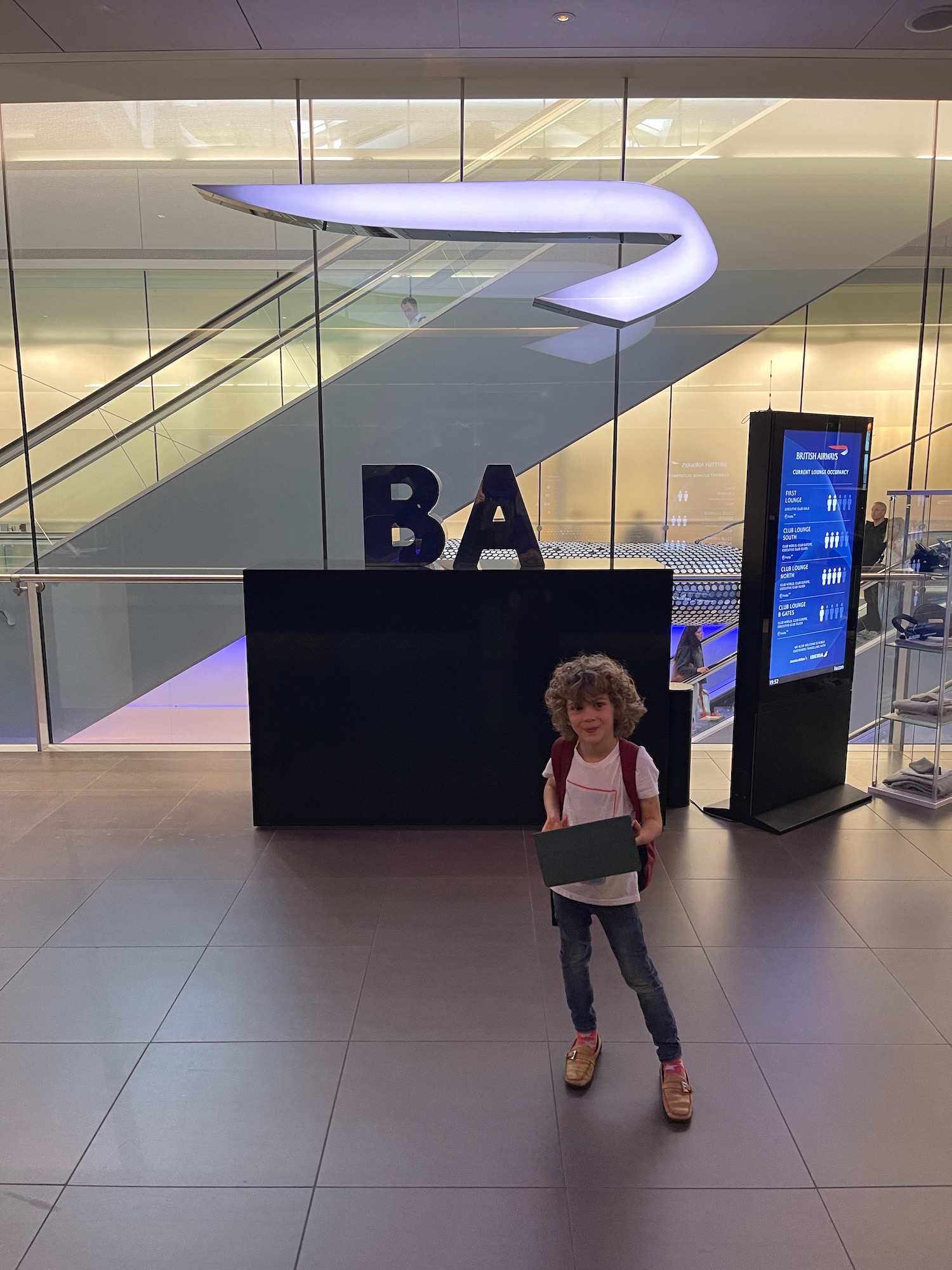 a child standing in a room with a sign