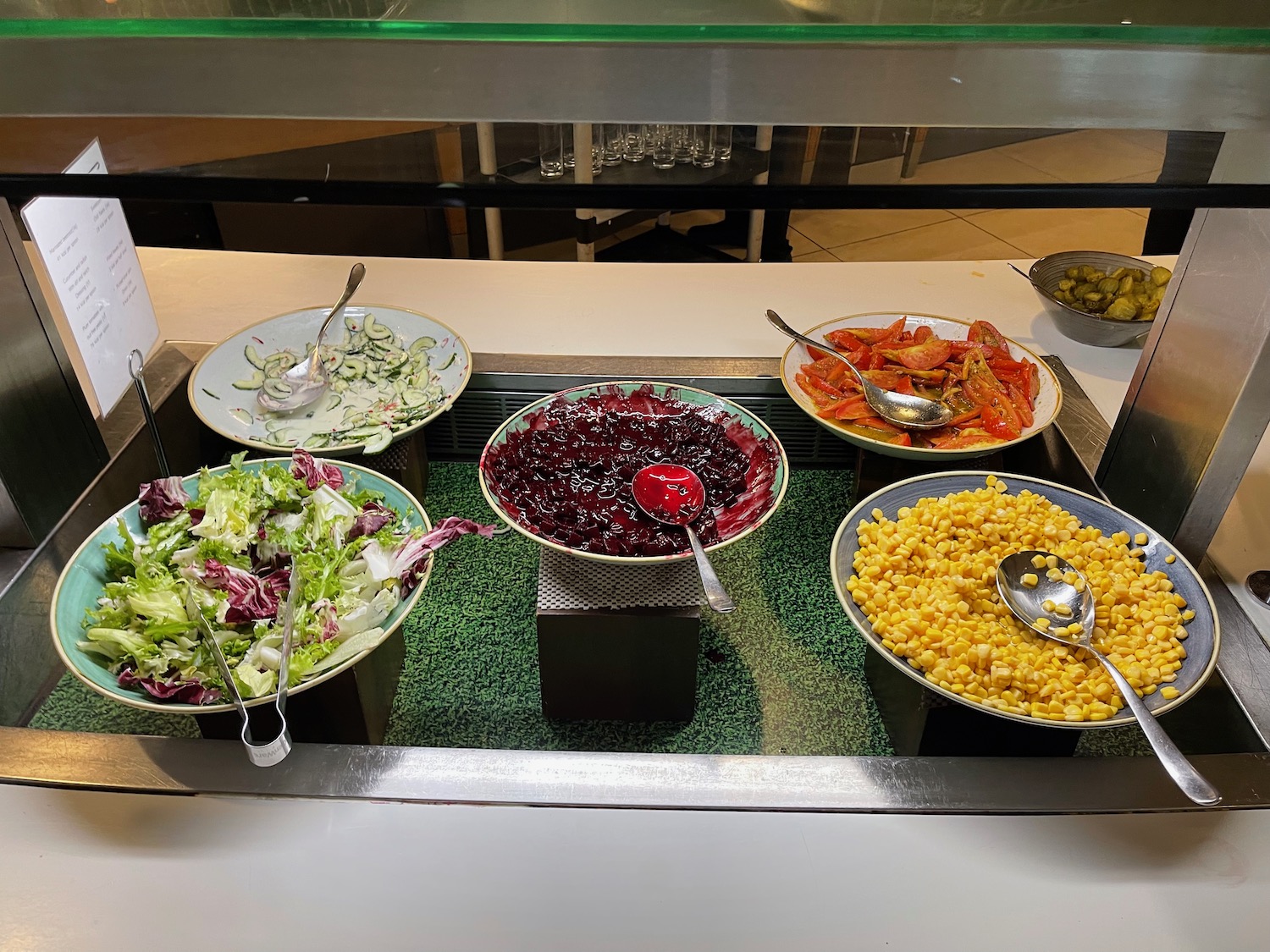 a buffet table with bowls of food