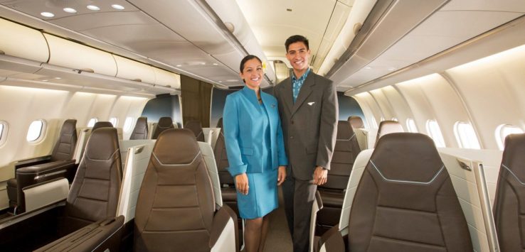 a man and woman standing in an airplane