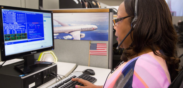 a woman wearing headset and using a computer