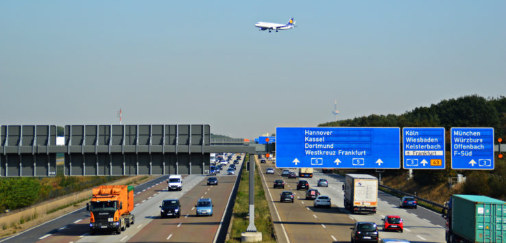 a plane flying over a highway