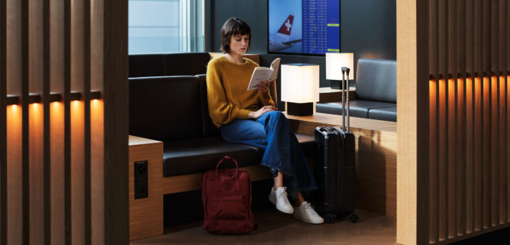 a woman sitting on a bench reading a book