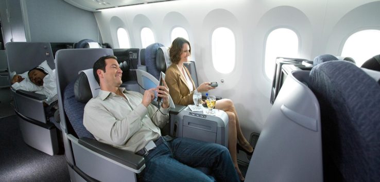 a man and woman sitting in an airplane