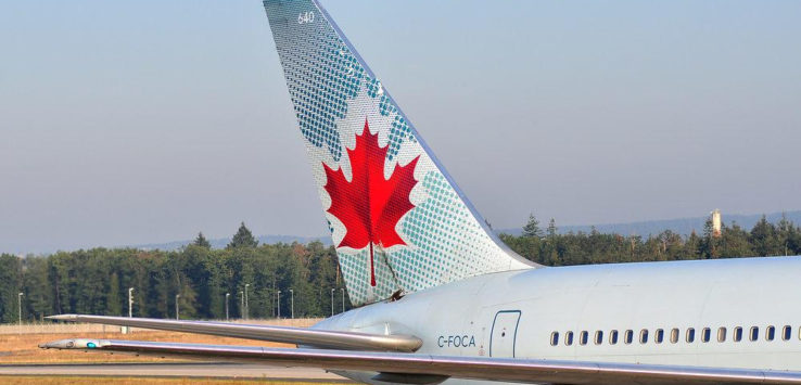 the tail of an airplane with a maple leaf on it