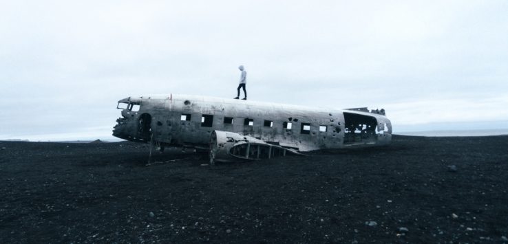 a person standing on top of an old plane