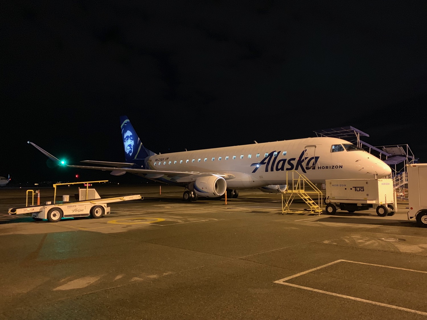 a plane parked on a tarmac at night