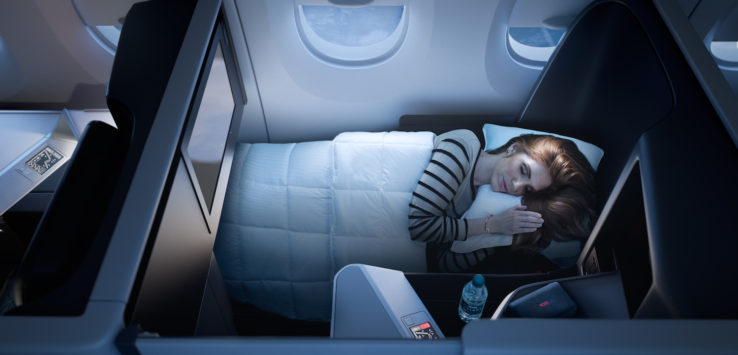 a woman sleeping in a plane