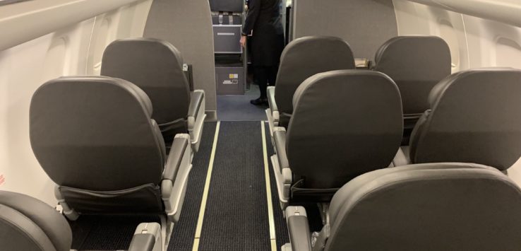 a woman standing in an airplane