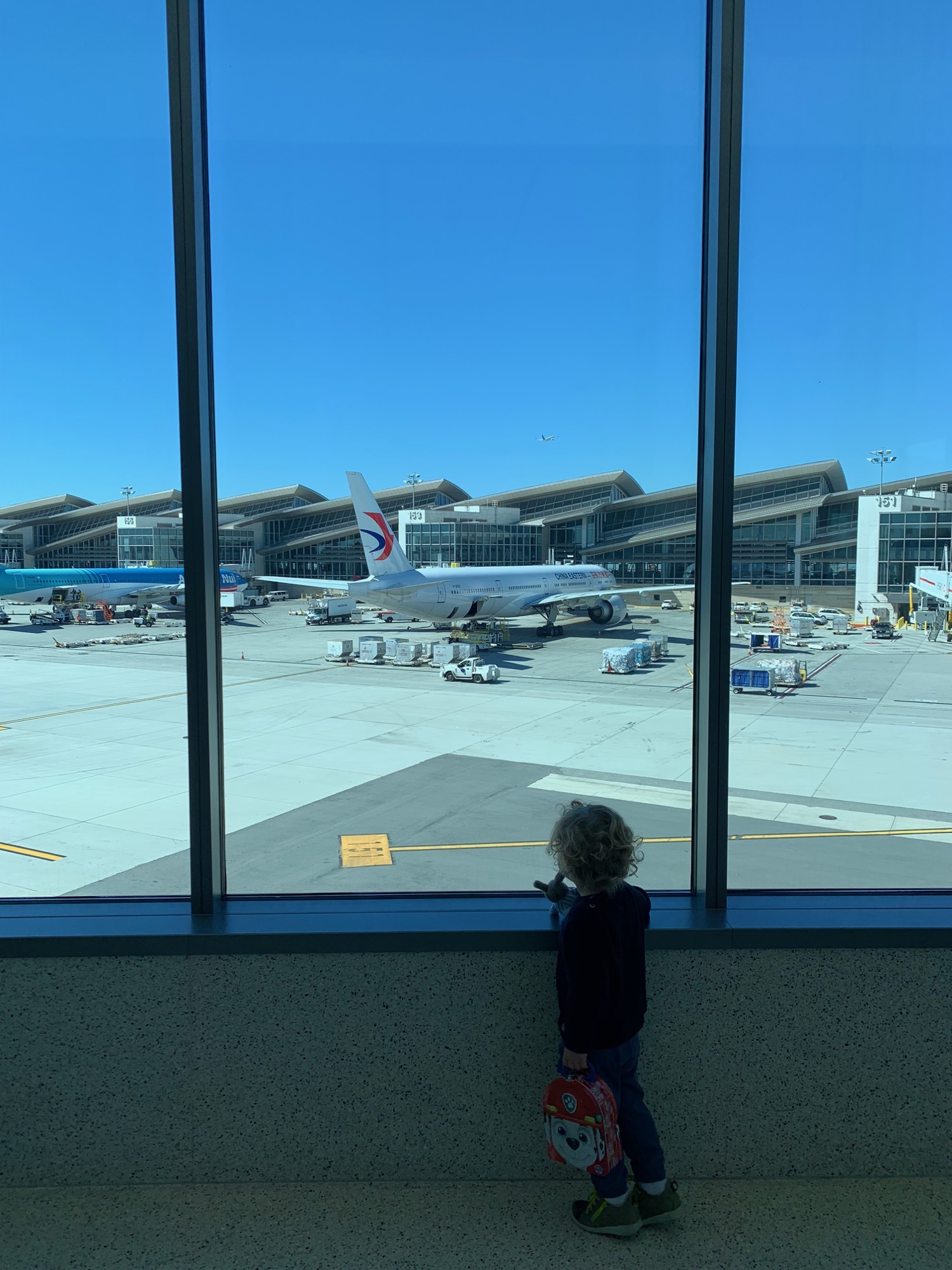 a child looking at an airplane