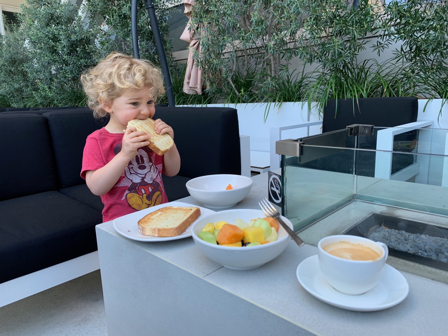 a child eating a sandwich at a table