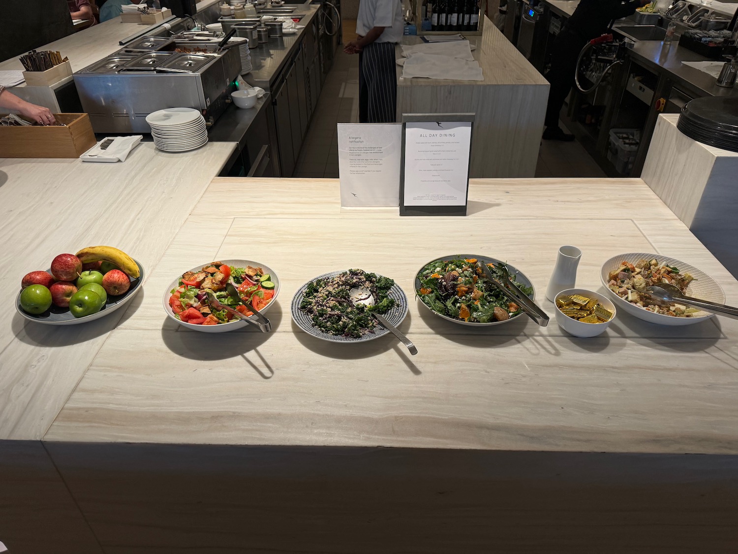 a row of bowls of food on a counter