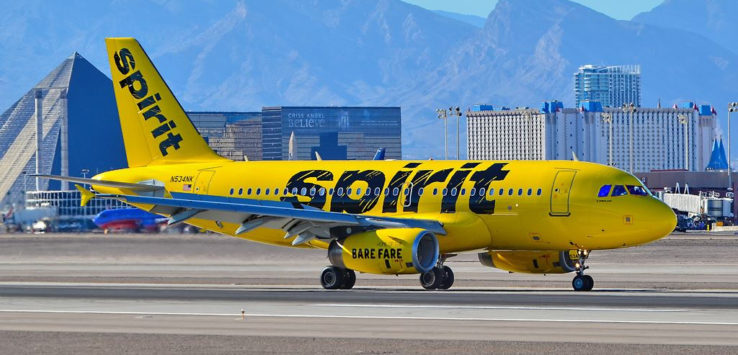 a yellow airplane on a runway