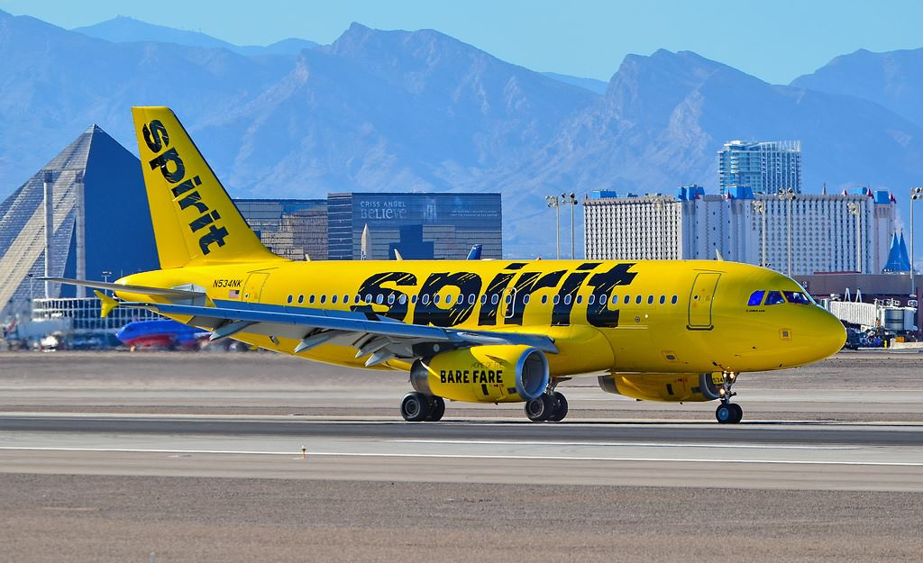 a yellow airplane on a runway