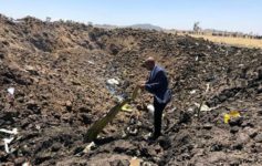 a man standing in a pile of dirt